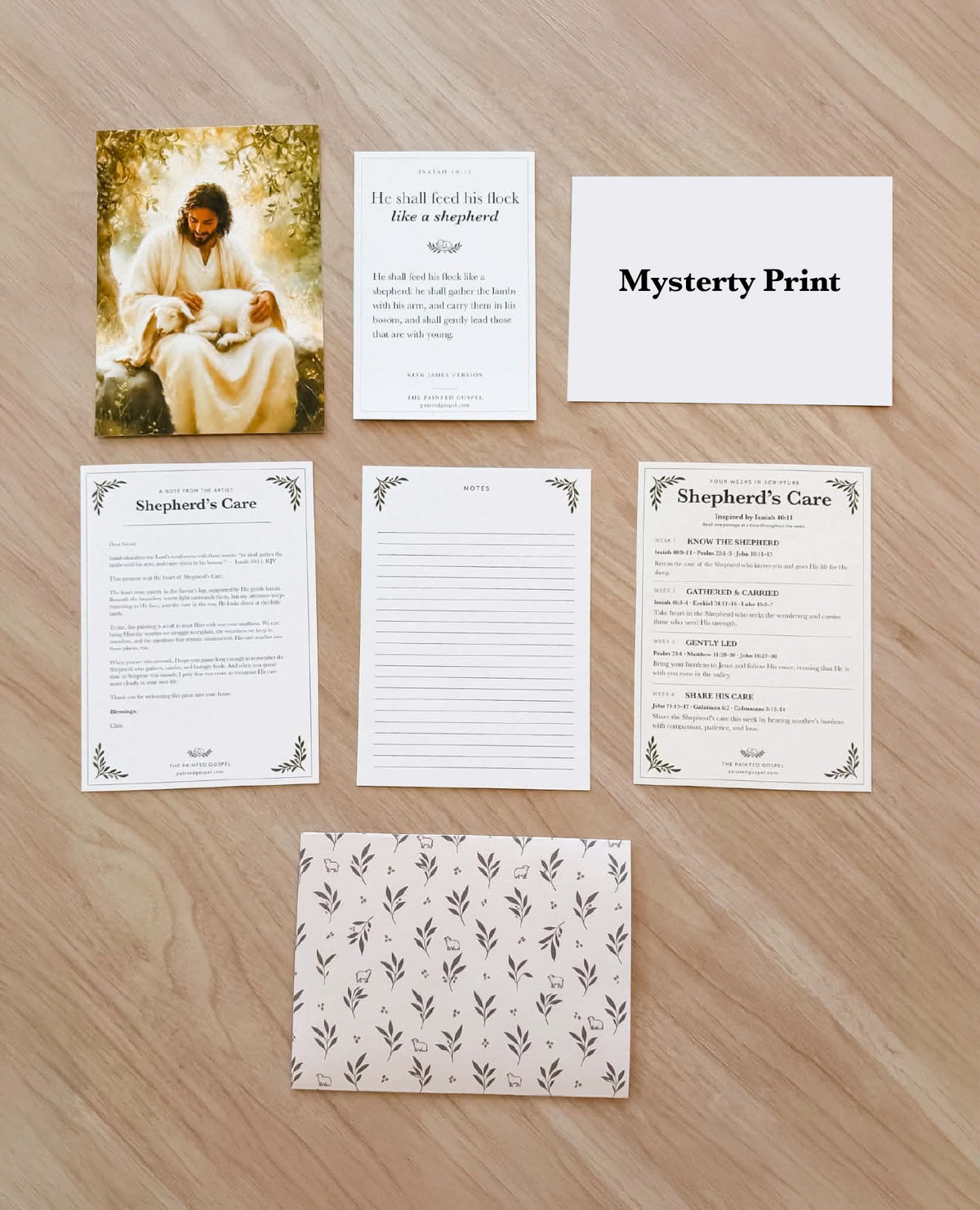 October Mail Club collection: Shepherd’s Care print, Isaiah 40:11 card, concealed mystery-print placeholder, artist letter, notes page, four-week Bible study, and patterned mailer.