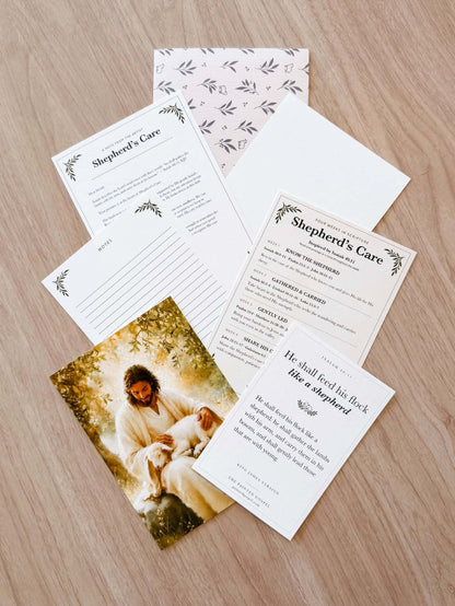 Actual Painted Gospel Mail Club collection with Savior-and-lamb print, Isaiah 40:11 Scripture card, artist letter, Bible study, notes page, and patterned mailer.