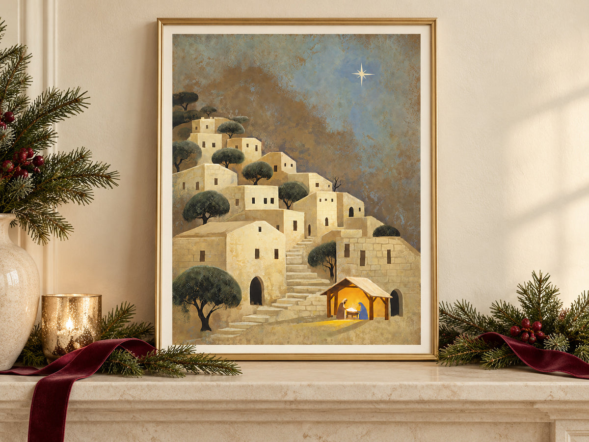 Light Over Bethlehem in a gold frame on a Christmas mantel with greenery and velvet ribbon