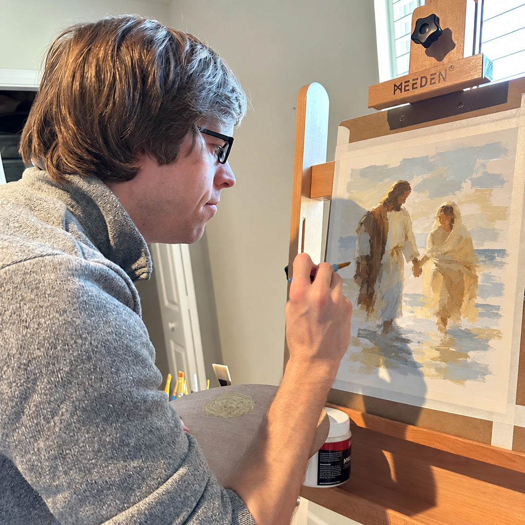 Chris at the easel with a digitally edited painting-in-progress preview.